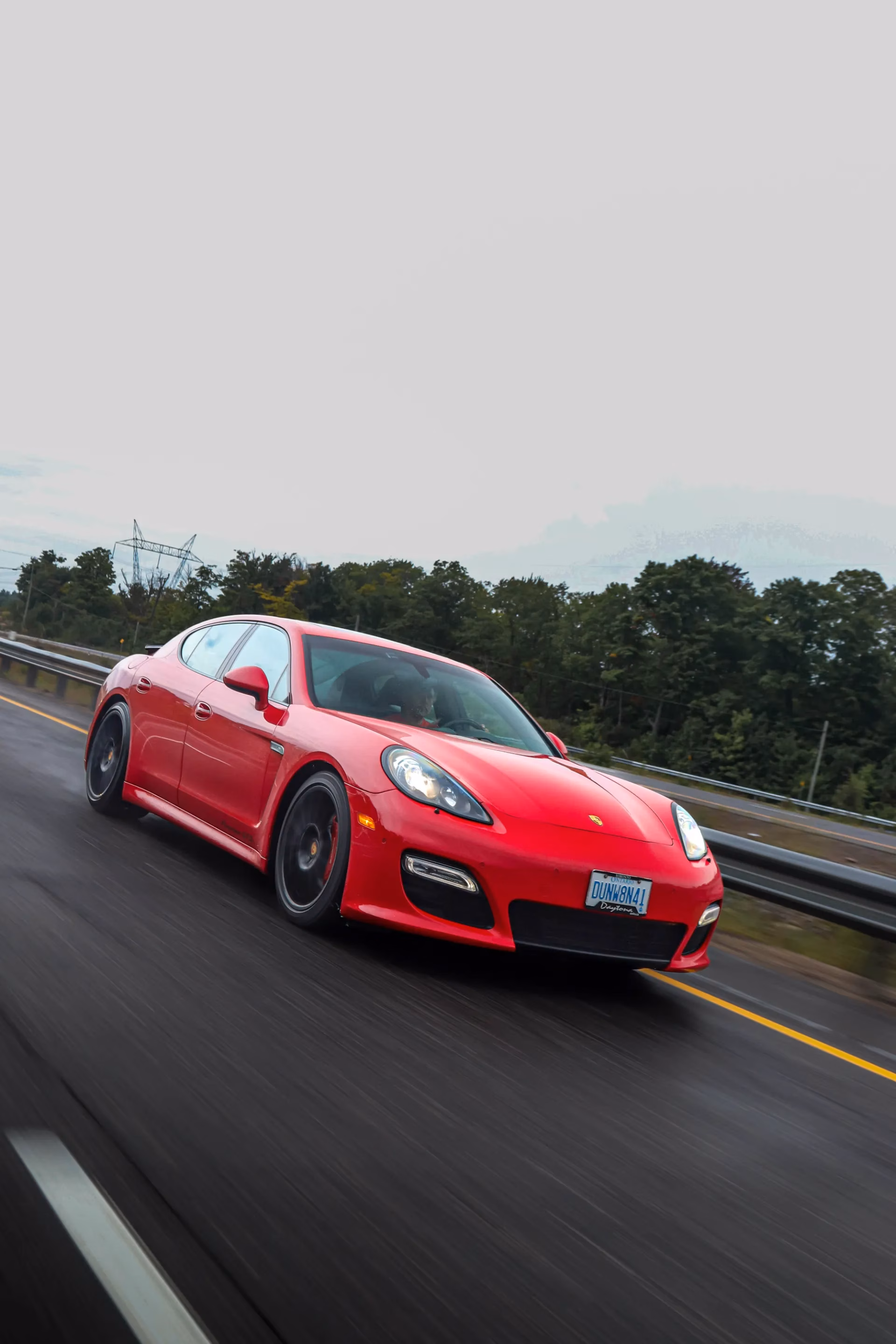 A red Porsche Panamera on the highway