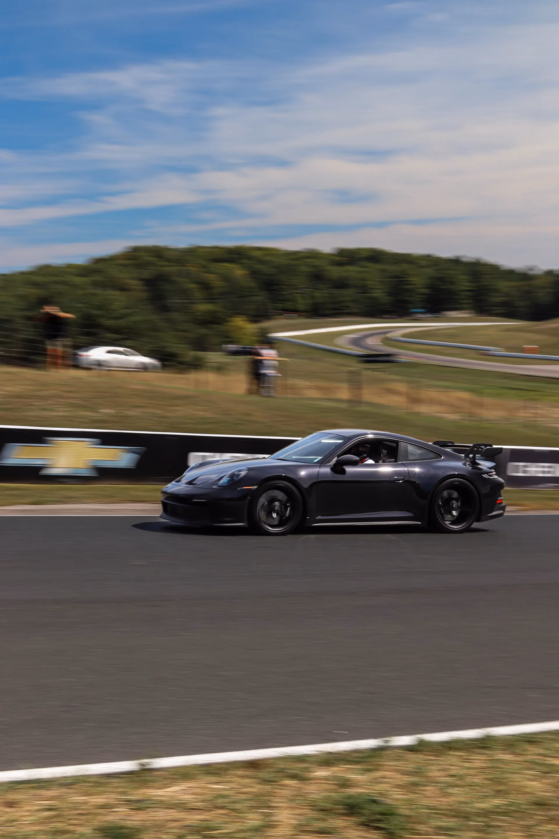 A dark Porsche 911 GT3 on track