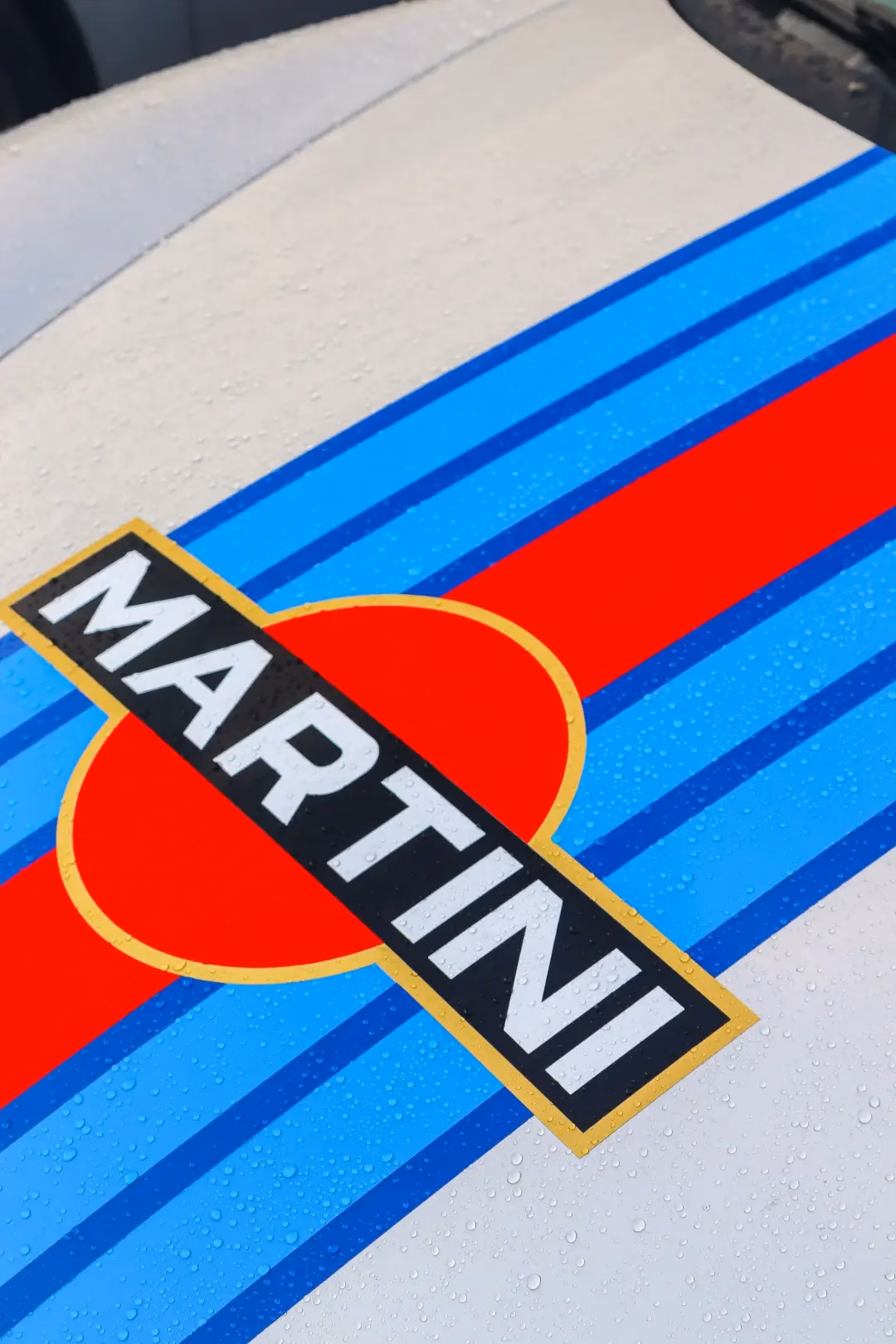 Close-up of Martini racing stripes and logo on a white car