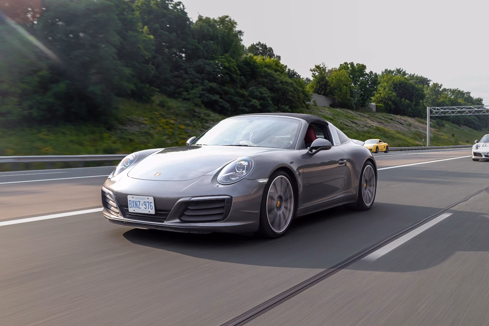 A grey Porsche 911 Targa on the highway